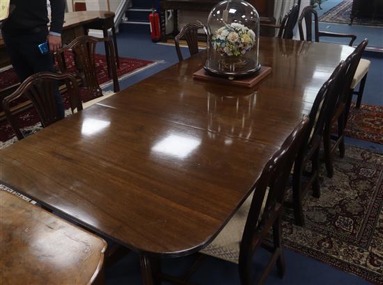 A Regency design mahogany two pillar dining table, L.257cm (two spare leaves)